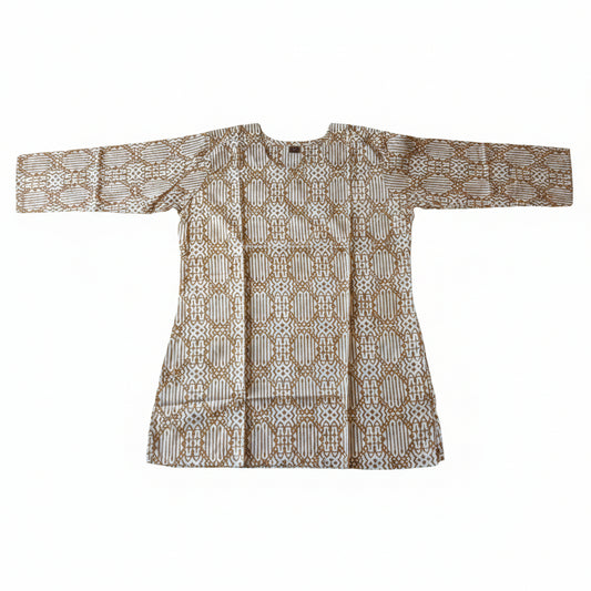 A long-sleeved batik tunic top with a brown and beige geometric pattern, laid flat on a bright green fabric background.