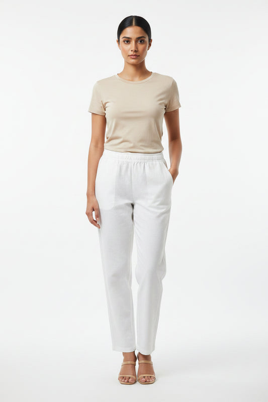 White casual pants featuring an elastic waistband and side pockets.