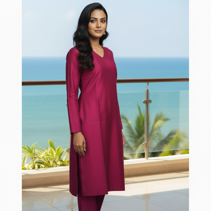 Woman in a magenta outfit standing on a city street